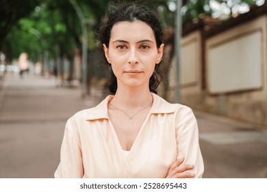 Young woman looking pensive at camera, standing on an empty street, reflecting a serious mood and contemplative expression in an outdoor urban environment, suggesting thoughtfulness and introspection - Powered by Shutterstock