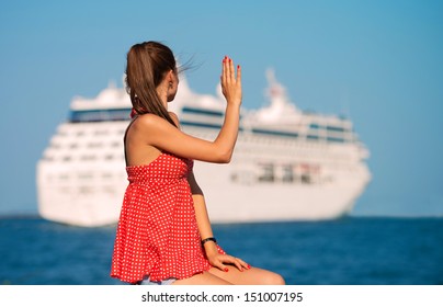 Young Woman Looking At The Ship And Waving Her Hand, View From The Back