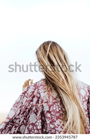 Similar – Image, Stock Photo Young woman wearing a flower shirt and using her phone