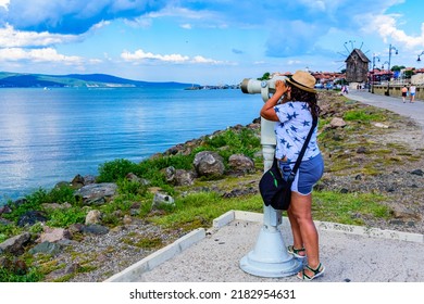 Young Woman Looking  To Slanchev Bryag (Sunny Beach) Through Telescope