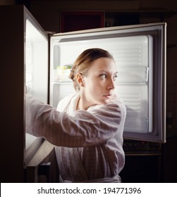 Young Woman Looking For Some Snack In Fridge Late At Night.