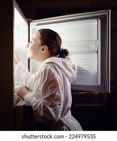 Young Woman Looking For Some Snack In Fridge Late At Night.