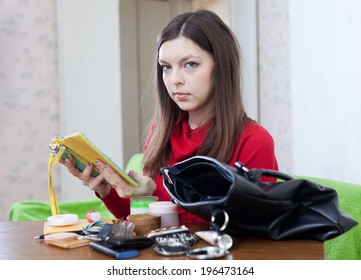 Young Woman Looking For Something In Her Purse