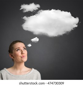 young woman looking and thinking with cloud over her head - Shutterstock ID 474730309