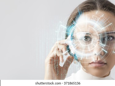 Young woman looking at virtual graphics in futuristic background