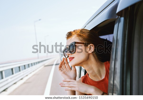 young woman
looks into the distance wearing
glasses