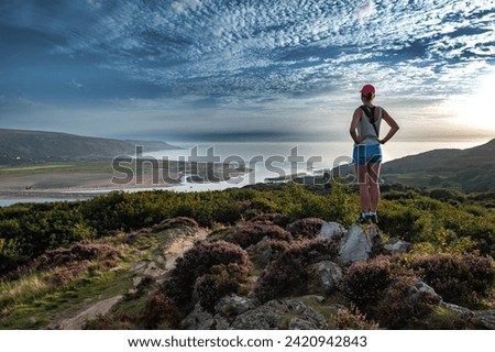 Young Woman Looks Over Mawddach River Estuary In Snowdonia National Park Near The City Of Barmouth In Wales, United Kingdom