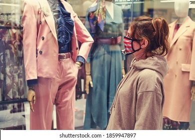 A Young Woman Looks At A Shop Window During The Coronavirus Epidemic In The United States.