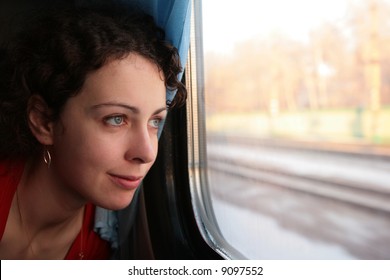 Young Woman Looks In Train`s Window