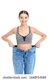 Young Woman In Loose Clothes On White Background. Weight Loss Concept