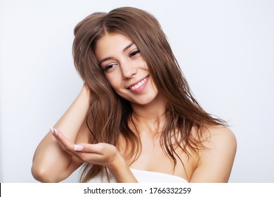 Young Woman With Luxurious Hair Applies Conditioner For Hair Care