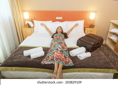 Young Woman Lying In The Bed Of A Hotel Room