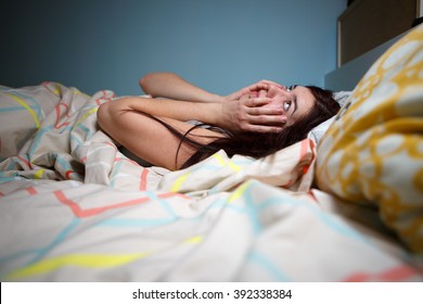 Young Woman Lying In Bed Suffering With Insomnia  Noisy Neighbour, Stress, Alarm Sound, Prevent From Sleep Concept