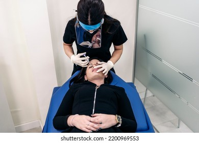 Young Woman Lying Down In Stretcher While Receiving Botulinum Toxin Injection In Beauty Clinic.