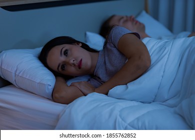 Young woman lying on the bed, that is sad quarrel with husband.
