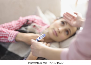 Young Woman Lying On Bed Had Fever And Chills Closeup