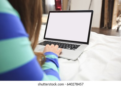 The Young Woman Is Lying On The Bed With A Laptop 