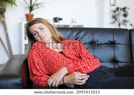 Similar – Happy girl using a smart phone sitting on a couch at home