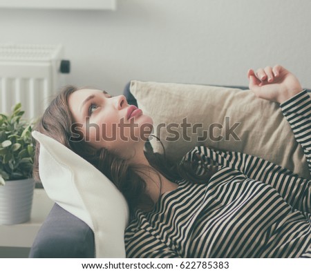 Young woman lying on a couch at home
