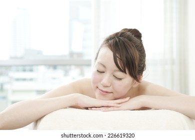 Young woman lying on a facial bed - Shutterstock ID 226619320