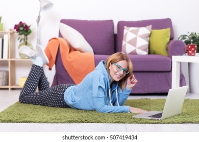 Young Woman Lying On The Floor With Lap Top Computer