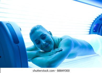 Young Woman Lying On Tanning Bed For A Beautiful Complexion