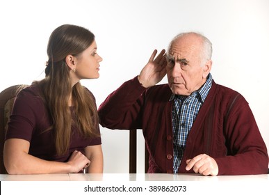 Young Woman Makes Hearing Test For Old Senior Man