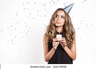 A Young Woman Makes A Wish With Cake