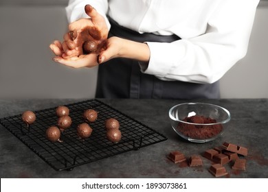 Young Woman Making Chocolate Truffle. Dark Background. Delicious Food Concept. Great Design For Any Purposes.