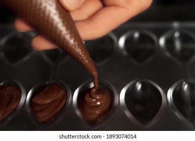 Young Woman Making Chocolate Truffle. Dark Background. Delicious Food Concept. Great Design For Any Purposes.