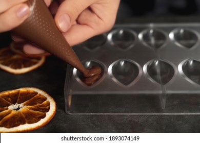 Young Woman Making Chocolate Truffle. Dark Background. Delicious Food Concept. Great Design For Any Purposes.