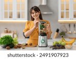 Young woman making delicious smoothie with blender at white marble table in kitchen