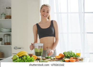 Young Woman Making Detox Smoothie At Home