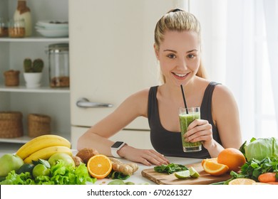 Young Woman Making Detox Smoothie At Home