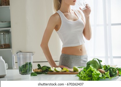 Young Woman Making Detox Smoothie At Home