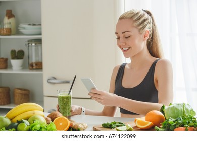 Young Woman Making Detox Smoothie At Home