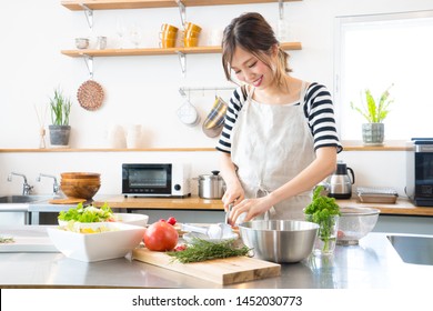 Young Woman Making Food In The Kitchen