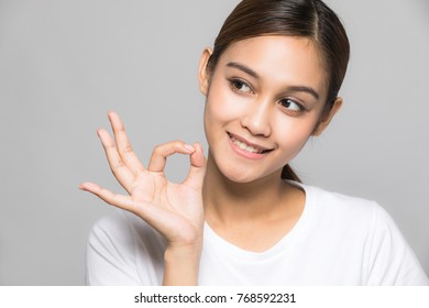 Young Woman Making OK Hand Sign.
