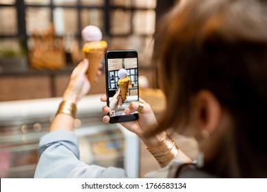 Young Woman Making A Photo Of Yummy Ice Cream In Waffle Cone Indoors. Buying Ice Cream At The Shop