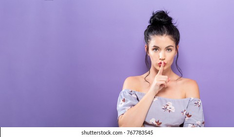 Young Woman Making A Quiet Gesture On A Solid Background