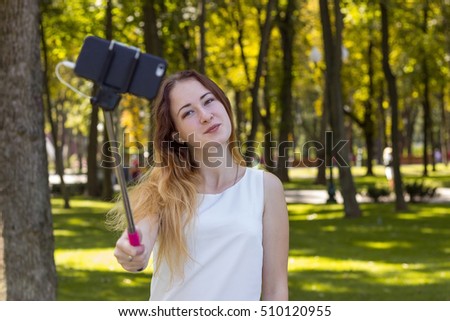 Young woman making selfie in the park