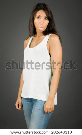 Young woman making silly face with sticking out her tongue