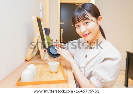 Young woman making a tea