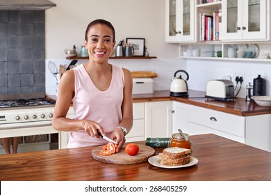 Young Woman Making Tomato Sandwich Kitchen At Home