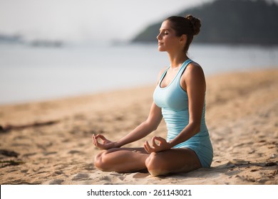 Young Woman Is Making Yoga On The Beach