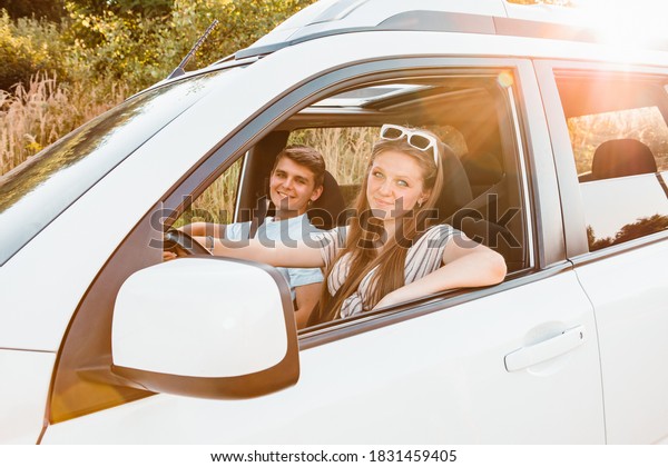 young woman with\
man in car. summer road\
trip