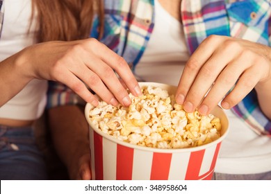 Young Woman And Man  Eating Popcorn In The Cinema