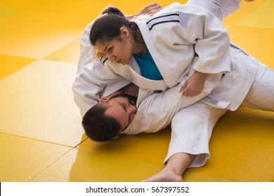 Young Woman And Man Judo Fighters In Sport Hall