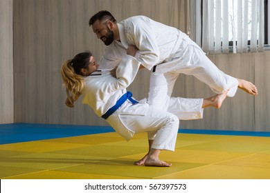 Young Woman And Man Judo Fighters In Sport Hall