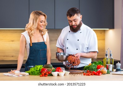 Young Woman And Man Prepare Food And Host A Cooking Show. The Bloggers Stream From Modern Kitchen. Healthy Food Preparation.